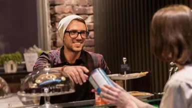 man serving customer cafe smiling great customer service
